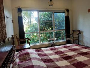 Postel nebo postele na pokoji v ubytování Adams Wood House Ayurveda Homestay Kochi