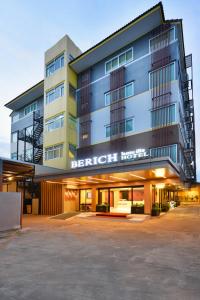 a building with a parking lot in front of it at Berich Hotel in Tak
