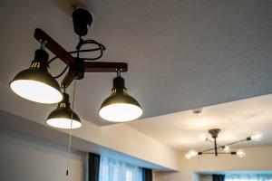 a group of lights hanging from a ceiling at MOXIE in Sapporo +152 photos