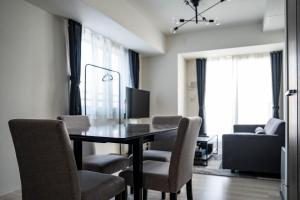a dining room with a table and chairs at MOXIE in Sapporo