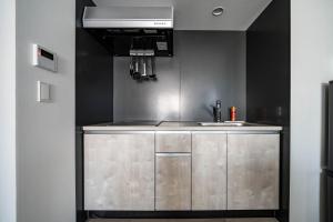 a kitchen with a sink and a microwave at MOXIE in Sapporo