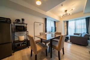 a living room with a dining room table and chairs at MOXIE in Sapporo