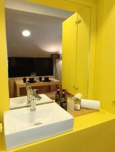 a bathroom with a white sink and a mirror at Yo'on Centro Histórico in San Cristóbal de Las Casas +16 photos