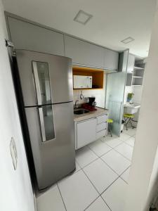 a kitchen with a stainless steel refrigerator at RioStay Apart com varanda em frente Riocentro Farmasi Arena Parque Olímpico Globo Projac in Rio de Janeiro
