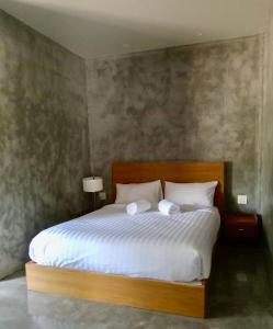 Postel nebo postele na pokoji v ubytování Coco Residence, Si Saket