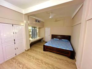 a bedroom with a bed in a room at Heritage Inn Homestay in Sibsāgar