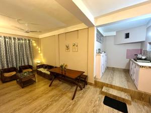 a living room with a couch and a table at Heritage Inn Homestay in Sibsāgar +9 photos