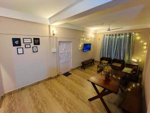 a living room with a couch and a table at Heritage Inn Homestay in Sibsāgar