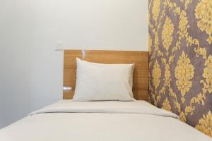 Кровать или кровати в номере Great Deal and Nice 2BR Citra Living Apartment By Travelio +7 фотографий