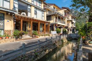 a group of buildings next to a river at Guilin Village Creek Inn & Free pick up service over three nights in Guilin