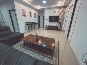 a living room with a coffee table and a piano at Full AC 3BR & Living Rm entire vacation home at Vigan City in Barraca