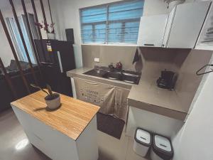 a small kitchen with a counter and a sink at Full AC 3BR & Living Rm entire vacation home at Vigan City in Barraca
