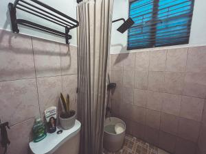 a bathroom with a shower curtain and a toilet at Full AC 3BR & Living Rm entire vacation home at Vigan City in Barraca +29 photos