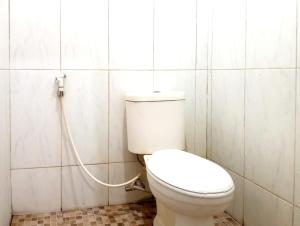 a bathroom with a toilet with a hose at Villa Cahaya 3 Guci Mitra RedDoorz in Tuwel +43 photos