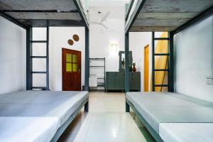 a bedroom with two beds and a ladder at Drifter - Rooms & Food in Midigama +37 photos
