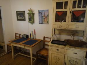 a kitchen with a sink and a table with a sink at Dominic Boutique Tamplarilor in Sighişoara