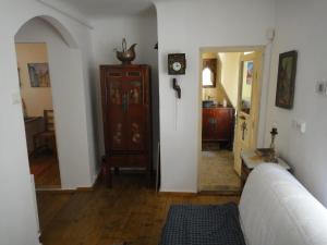 a living room with a couch and a clock on the wall at Dominic Boutique Tamplarilor in Sighişoara