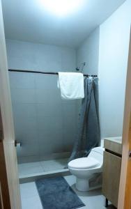a white bathroom with a toilet and a shower at Amazing Monterrey Getaway 3 in Monterrey