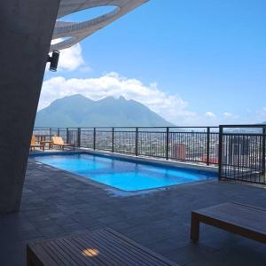 a swimming pool with a view of a mountain at Prime Monterrey Stay 4 in Monterrey +7 photos