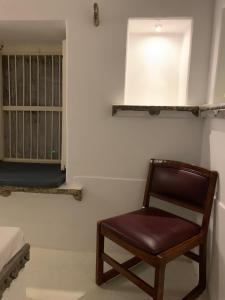a chair sitting in a room with a bedroom at Peacock Guest House - Lake View Hotel In Udaipur in Udaipur +69 photos