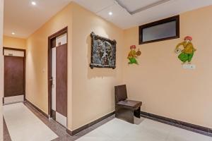 a hallway with a door and paintings on the wall at Super Capital O Townhouse Govinda Royal in Kānpur