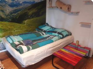 a bed in a room with a painting on the wall at Ferienwohnung Apartment modern, bis 4 Personen, Altstadt fußläufig in Landshut