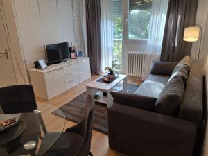a living room with a couch and a table at Apartman TEO, self check-in, free parking in Slavonski Brod