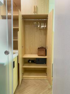 a cupboard with a door open to a kitchen at Elambo Space - Không gian nghỉ dưỡng sân vườn gần biển in Da Nang