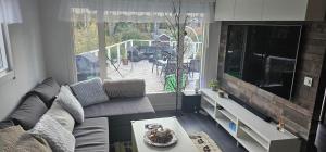 a living room with a couch and a large window at Villa Relax in Mölnbo