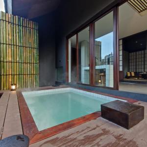 a swimming pool in a house with windows at Addostays - Mori Machiya in Bandung