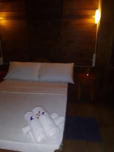 a bedroom with a bed with towels on it at The Cinnamon Farm Wooden Cabana Unawatuna in Unawatuna
