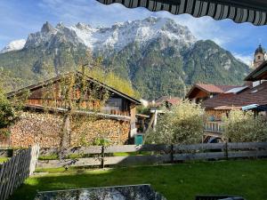 a view of a mountain range from a village at Ferienwohnung mit Terrasse und Garten mit Blick auf das Karwendelgebirge in Mittenwald