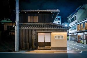 a building with a door on the side of a street at Ichika Machiya House in Takayama