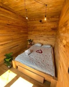 a bedroom with a bed in a wooden room at IDEA Wypoczynek Domek Jezioro Białe in Okuninka