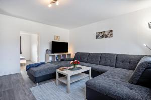 a living room with a couch and a table at tierfreundliche Ferienwohnung in Adamshoffnung