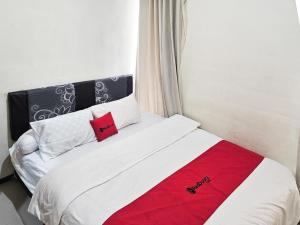 Ένα ή περισσότερα κρεβάτια σε δωμάτιο στο RedDoorz Syariah Nanna Homestay Near Dino Park +65 φωτογραφίες