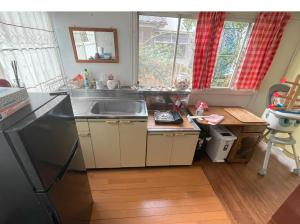 a kitchen with a sink and a counter top at Tatami room & Living Room equipped with Multinational TV and Fire, BBQ corner in Tokyo Downtown House in Tokyo