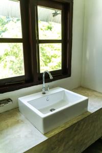 a white sink in a bathroom with a window at Drifter - Rooms & Food in Midigama