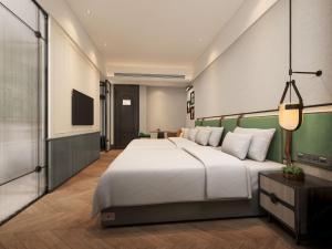Ένα ή περισσότερα κρεβάτια σε δωμάτιο στο Renjoy Hotel -Xiamen Zhongshan Road Pedestrian Street