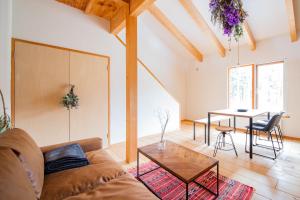 a living room with a couch and a table at FamA in Nakafurano