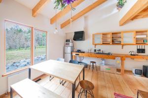 a kitchen and dining room with a table and chairs at FamA in Nakafurano +17 photos