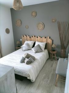 ein Schlafzimmer mit einem großen weißen Bett mit zwei Kissen in der Unterkunft Maison au calme in Bournainville