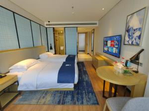 Katil atau katil-katil dalam bilik di Echarm Hotel Dongxing Minzu Road