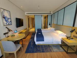 Katil atau katil-katil dalam bilik di Echarm Hotel Dongxing Minzu Road
