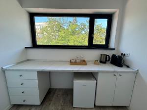 a desk in a room with a window at Axon Apartments in Oradea