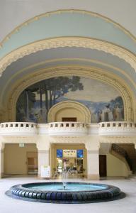 a large fountain in the middle of a building with a painting at Hotel Ibis Budget Vichy in Bellerive-sur-Allier