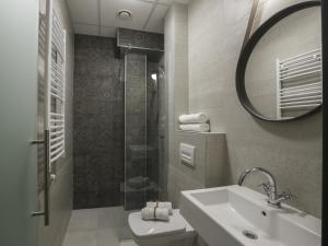 a bathroom with a sink and a shower and a mirror at Savamala Place in Belgrade