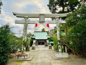 a japanese shrine with a gate in the background at House33 Iwai in Ichibu