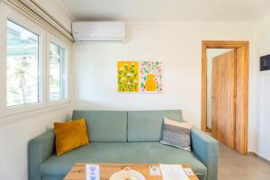 a living room with a couch and a table at Oasis Apartments Maggana Xanthi in Xanthi