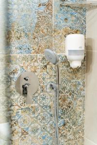 a shower with a faucet in a bathroom at Oasis Apartments Maggana Xanthi in Xanthi +20 photos